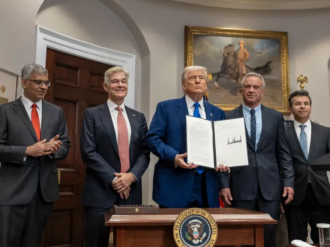 President Trump holds up his signed executive order aimed at lower drug prices